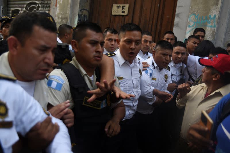Police officers stand guard on the street of the Congress of Guatemala, in Guatemala City