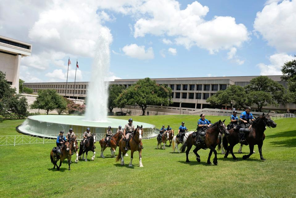 Mounted patrol officers guard the perimeter outside the LBJ Presidential Library Monday July 29, 2024, before President Joe Biden spoke at an event there.