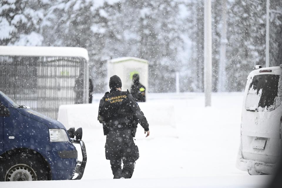 A Finnish Border Guard walks in the snow at the Raja-Jooseppi international border crossing station between Russia and Finland, in Inari, northern Finland, Saturday, Nov. 25, 2023. The European Union’s border agency says that it will send dozens of officers and equipment as reinforcements to Finland to help police its borders amid suspicion that Russia is behind an influx of migrants arriving to the country. (Emmi Korhonen/Lehtikuva via AP)