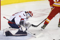 Washington Capitals goalie Vitek Vanecek, left, makes a save against Calgary Flames' Dillon Dube during the first period of an NHL hockey game Tuesday, March 8, 2022, in Calgary, Alberta. (Larry MacDougal/The Canadian Press via AP)