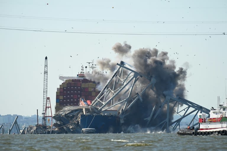 Crews conduct a controlled demolition of a section of the Francis Scott Key Bridge resting on the Dali container ship in Baltimore on May 13, 2024 (ROBERTO SCHMIDT)