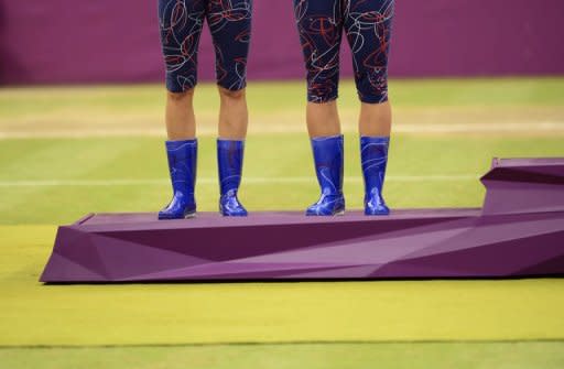 The blue boots of Czech Republic's Andrea Hlavackova (left) and Lucie Hradecka as they stand on the podium after receiving their silver medals for the Olympics tennis women's doubles. Experts say fashions at the Olympics have shown as much bad taste as elegance