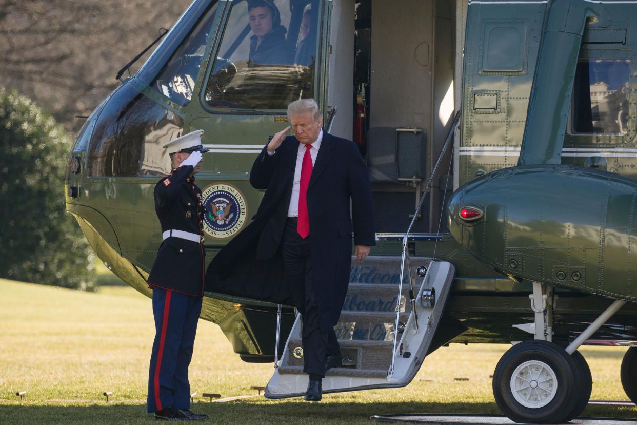 President Donald Trump salutes as he steps off Marine One on the South Lawn of the White House, Jan. 6, 2019, in Washington.