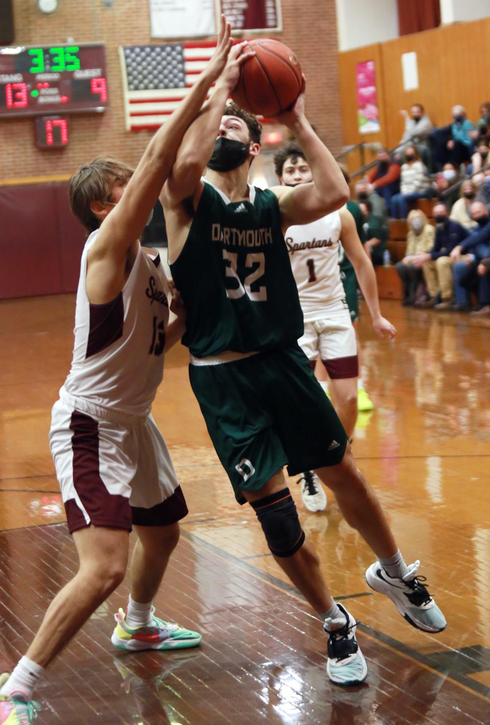 Mason Bouchard takes it up strong with Frank Vollaro defending Friday in Bishop Stang's 63-49 win over Dartmouth at the John C. O'Brien Gymnasium.