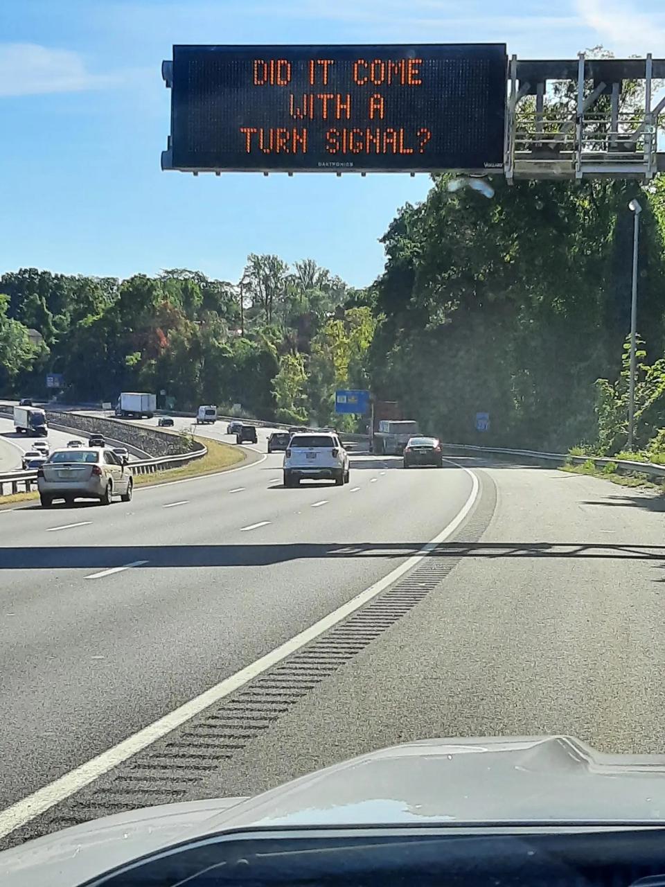A New Jersey Department of Transportation roadside safety sign saying: "Nice car, does it come with a turn signal?"