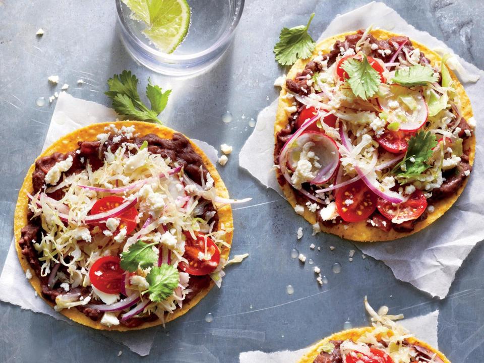 <p>Look for salty crumbly fresh Mexican cheese—queso fresco—near other fresh cheeses. Swap crumbled feta or shredded Jack cheese in a pinch. Look for crunchy premade tostada shells near the taco shells. Use up the extra shells as a base for a batch of after-school nachos, or break them into pieces and use in place of tortilla chips. For even more veggie goodness and an extra punch of flavor, try adding a few slices of creamy avocado and a sprinkle of charred corn kernels.</p> <p><a href="https://www.myrecipes.com/recipe/black-bean-tostadas-with-cabbage-slaw" rel="nofollow noopener" target="_blank" data-ylk="slk:Black Bean Tostadas with Cabbage Slaw Recipe;elm:context_link;itc:0;sec:content-canvas" class="link ">Black Bean Tostadas with Cabbage Slaw Recipe</a></p>