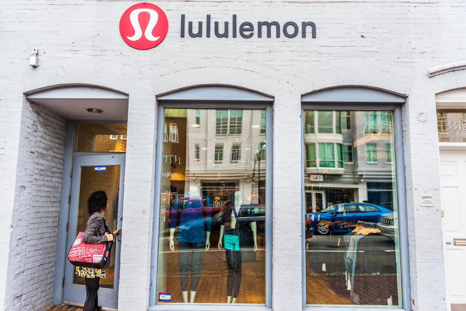 Washington DC: Lululemon building exterior with woman entering store by sign.