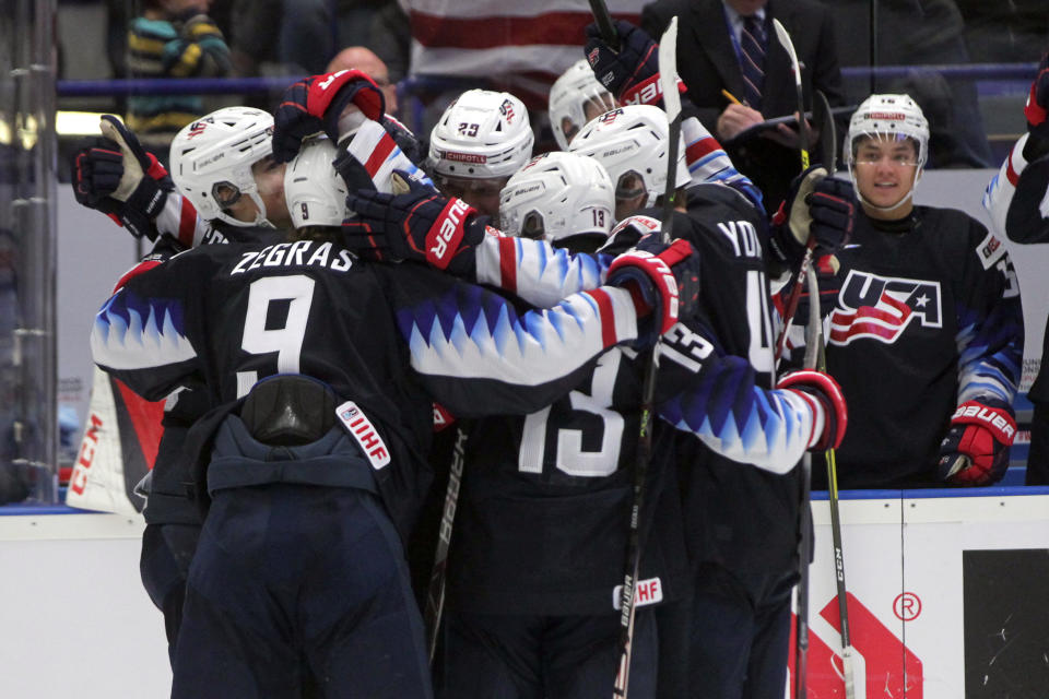 USA players celebrate their first goal during the 2020 IIHF World Junior Ice Hockey Championships Group B match between USA and Russia in Ostrava, Czech Republic, Sunday, Dec. 29, 2019. (Petr Sznapka/CTK via AP)