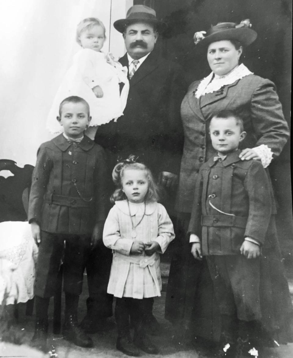 Galdino Borradori holds son Dante in Gordola, Switzerland. Also pictured are, standing from bottom left, sons Samuel, Edward and Alfred and wife Priscilla.