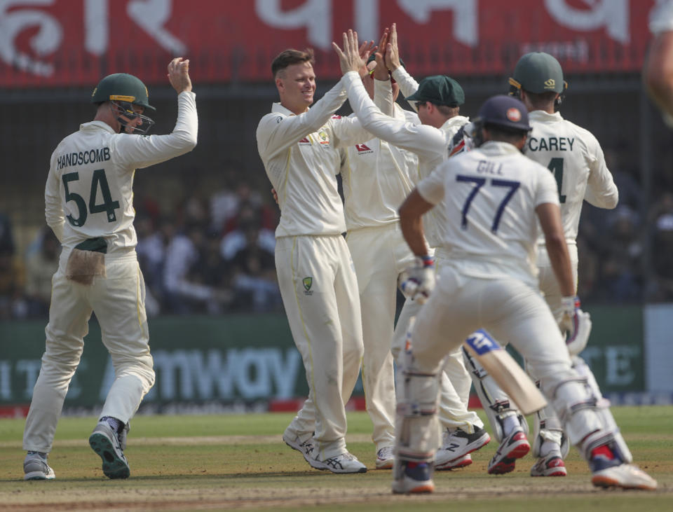 Australia's Matthew Kuhnemann, second left without cap, celebrates with his teammates the dismissal of India's Cheteshwar Pujara during the first day of third cricket test match between India and Australia in Indore, India, Wednesday, March 1, 2023. (AP Photo/Surjeet Yadav)