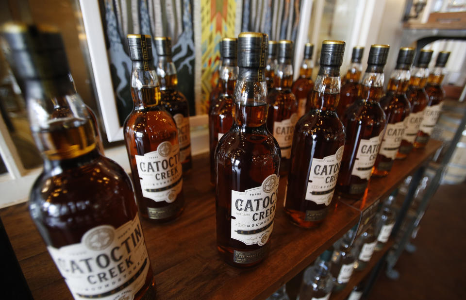 FILE - In this June 20, 2018 file photo, Catoctin Creek Distillery whiskey is on display in a tasting room in Purcellville, Va. For American whiskey producers, it’s a hangover that’s getting worse as a tariff-induced downturn in exports accelerates. And the pain is felt the most in the industry’s key European markets, an industry trade group said Thursday, March 21, 2019. (AP Photo/Steve Helber, File)