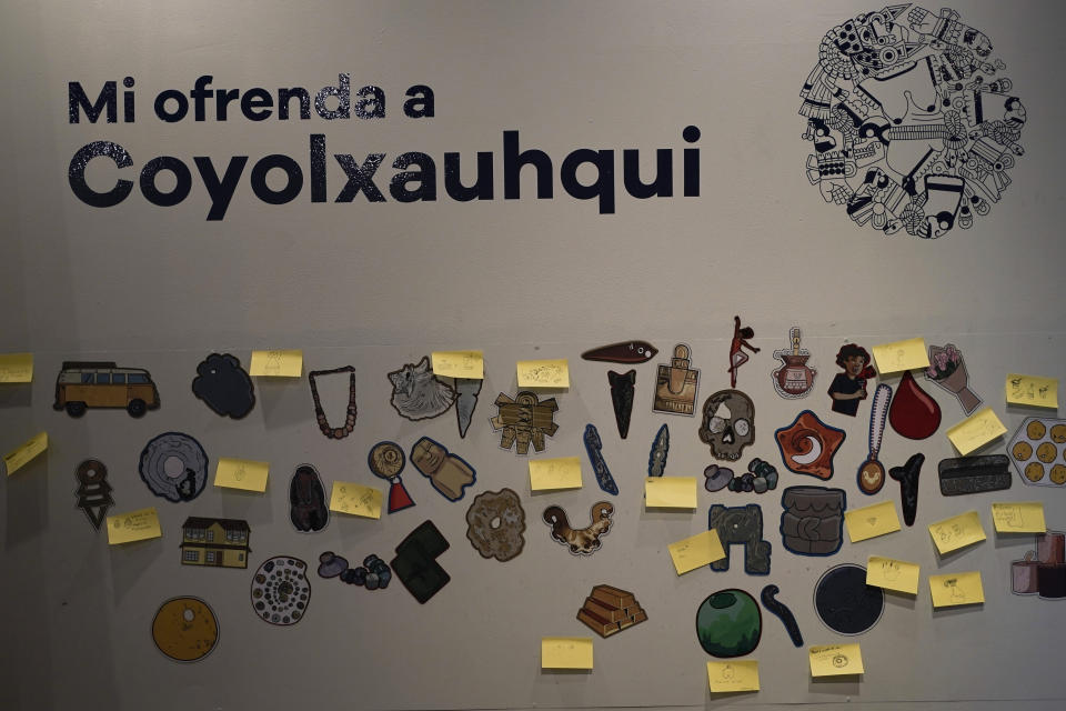 Sticky notes with messages and drawings depicting offerings left by visitors for the Mexica lunar goddess Coyolxauhqui, are posted on a wall at the Museum of Templo Mayor in Mexico City, Wednesday, March 29, 2023. A new exhibit at the museum marks the 45th anniversary of the discovery of a monolith depicting Coyolxauhqui. (AP Photo/Eduardo Verdugo)