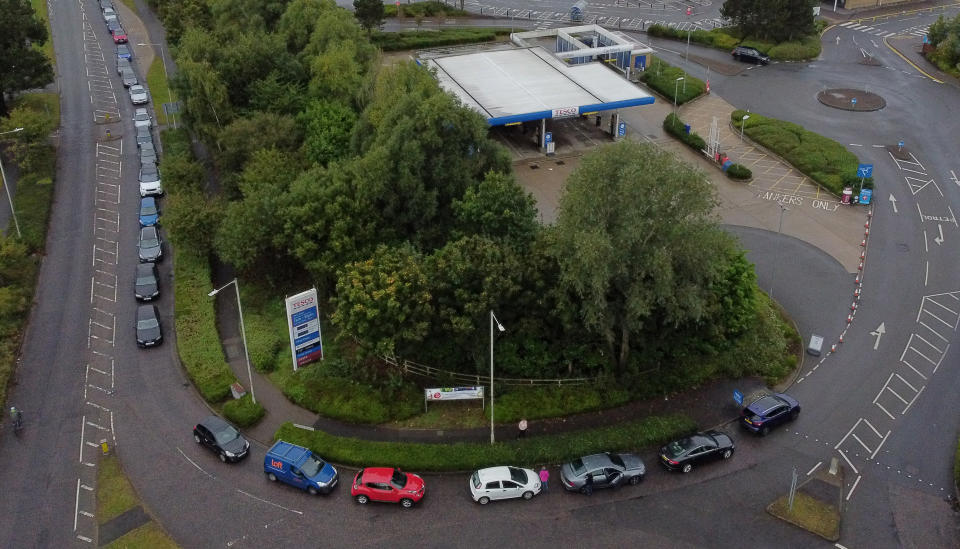 Motorists queue for a petrol station to open at a Tesco in Ashford, Kent. Picture date: Sunday October 3, 2021.