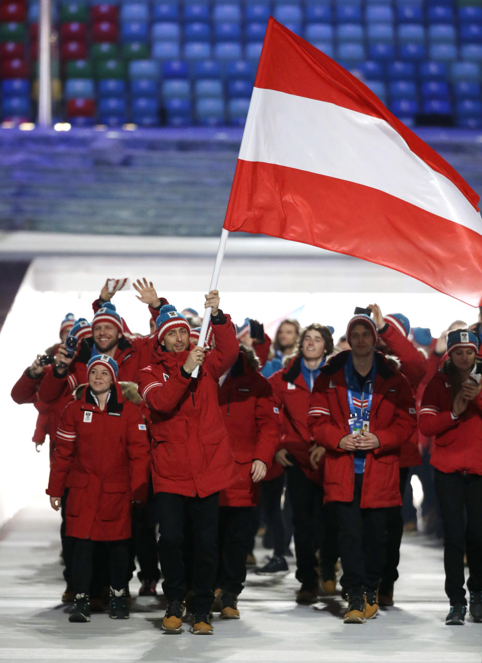 Mario Strecher of Austria carries the national flag as he leads the team during the opening ceremony of the 2014 Winter Olympics in Sochi, Russia, Friday, Feb. 7, 2014. (AP Photo/Mark Humphrey)