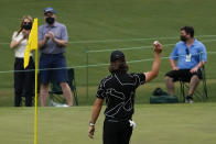 Tommy Fleetwood, of England, holds up his ball after a hole-in-one on the16th hole during the first round of the Masters golf tournament on Thursday, April 8, 2021, in Augusta, Ga. (AP Photo/Gregory Bull)