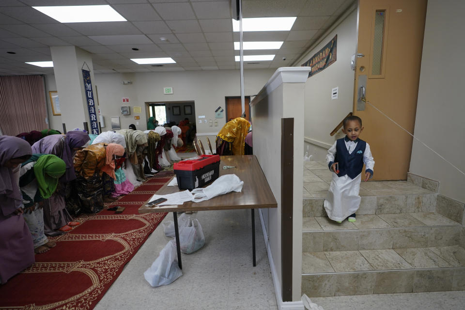 A small boy moves around the room as women pray during Eid al-Fitr, Friday, April 21, 2023, at the Muslim Community Center in Silver Spring, Md. Eid al-Fitr marks the end of the Muslim holy fasting month of Ramadan.(AP Photo/Carolyn Kaster)