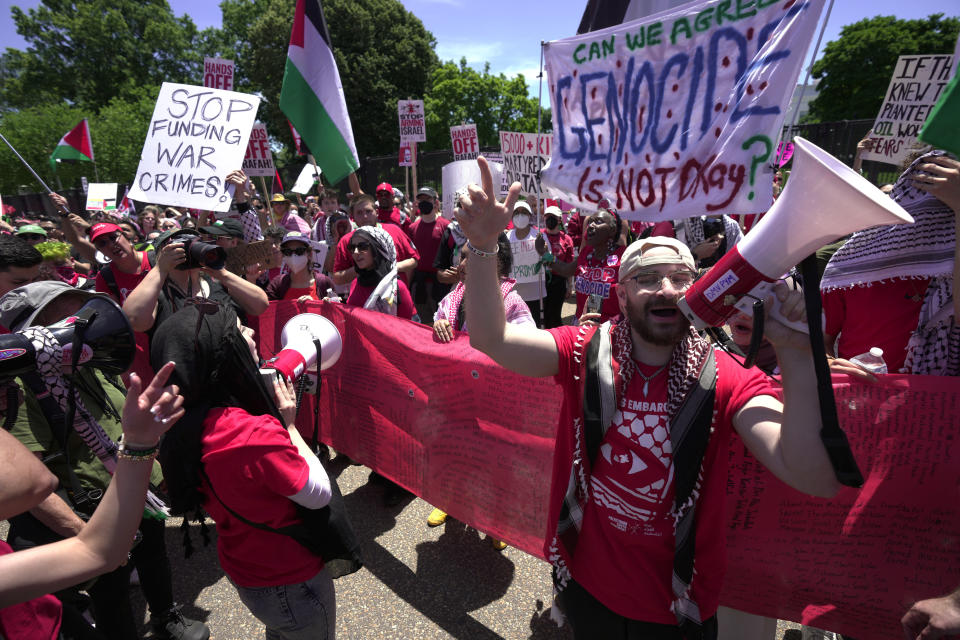 Pro-Palestinian protesters carry a red banner representing a "red line" in front of the White House in Washington, Saturday, June 8, 2024. (AP Photo/Manuel Balce Ceneta)