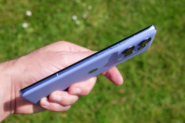 A person holding the Motorola Edge 50 Pro, showing the buttons.