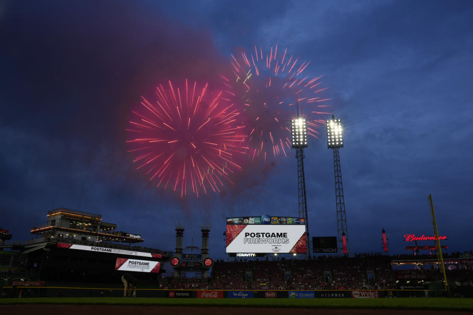 Fireworks explode above Great American Ball Park before a baseball game between the Baltimore Orioles and the Cincinnati Reds, Friday, May 3, 2024, in Cincinnati. The planned postgame fireworks were fired before the game because of a rain delay. (AP Photo/Carolyn Kaster)