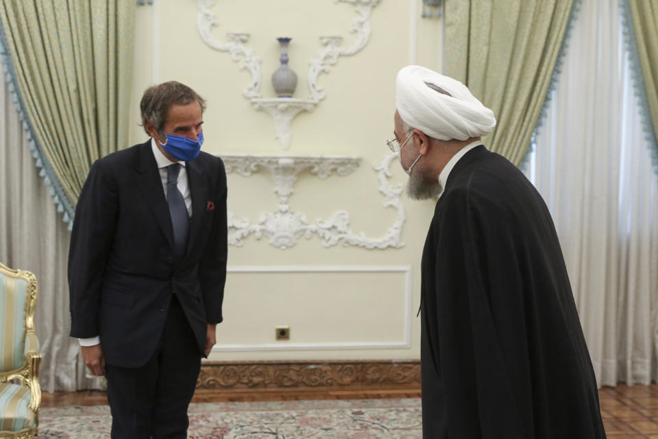 FILE - In this Aug. 26, 2020 file photo, released by the official website of the office of the Iranian Presidency, President Hassan Rouhani, right, welcomes Director General of International Atomic Energy Agency, IAEA, Rafael Mariano Grossi for their meeting in Tehran, Iran. Iran urged the United Nations' nuclear watchdog to avoid publishing “unnecessary” details on Tehran’s nuclear program, state TV reported Sunday, Jan. 17, 2021, a day after Germany, France and Britain said Tehran has “no credible civilian use” for its development of uranium metal. (Iranian Presidency Office via AP, File)