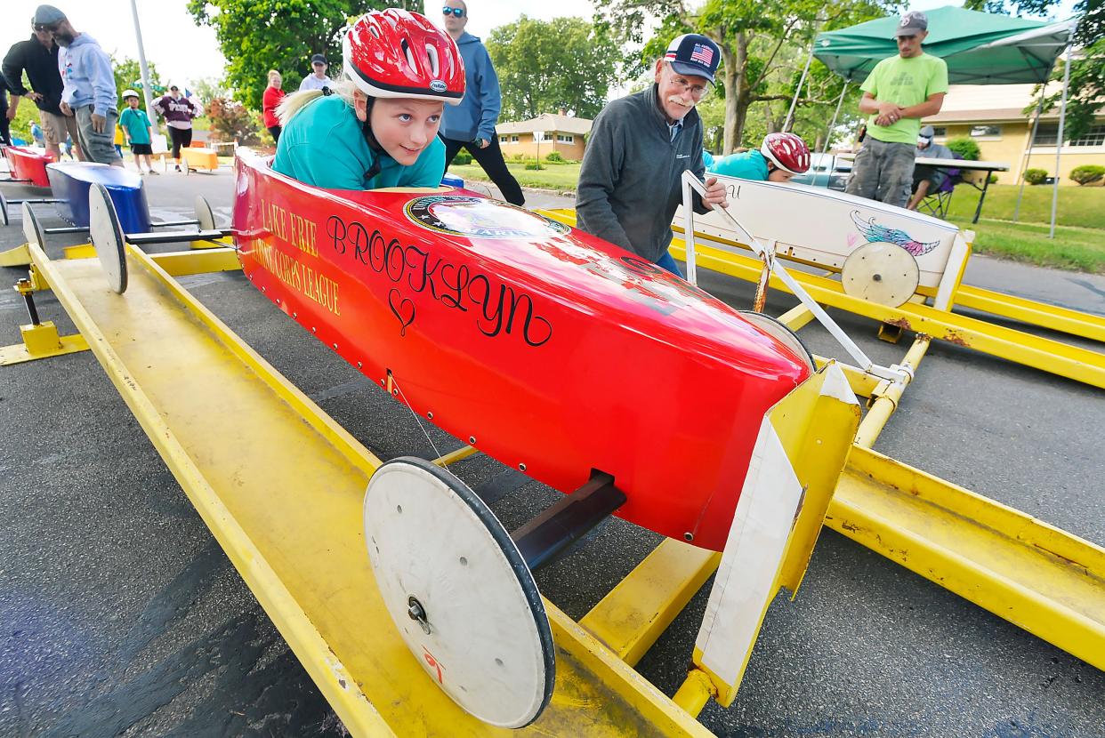 In this 2022 file photo, then 9-year-old Brooklyn Fry gets set for her first test run before competing in the Erie All-American Soap Box Derby on the east side of State Street, from 33rd to 37th street, on June 18. Volunteer Bryan Johnson, center, father of first-year race director Adam Johnson, started the races. Twenty-three cars were driven by youth ages 7-21.