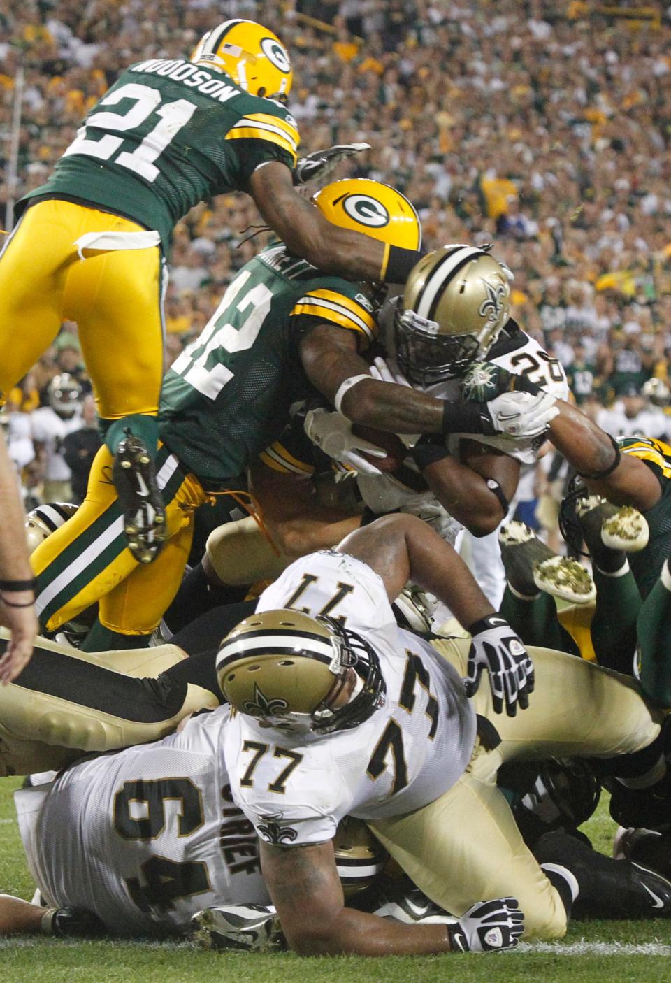 New Orleans Saints running back Mark Ingram is stopped on the goal line by Green Bay Packers Morgan Burnett and Clay Matthews with no time remaining.