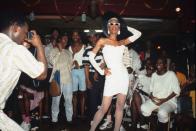 <p>This unidentified diva caught everyone's eyes at a Harlem drag ball, wearing elbow-length gloves and a strapless bodycon dress.</p>