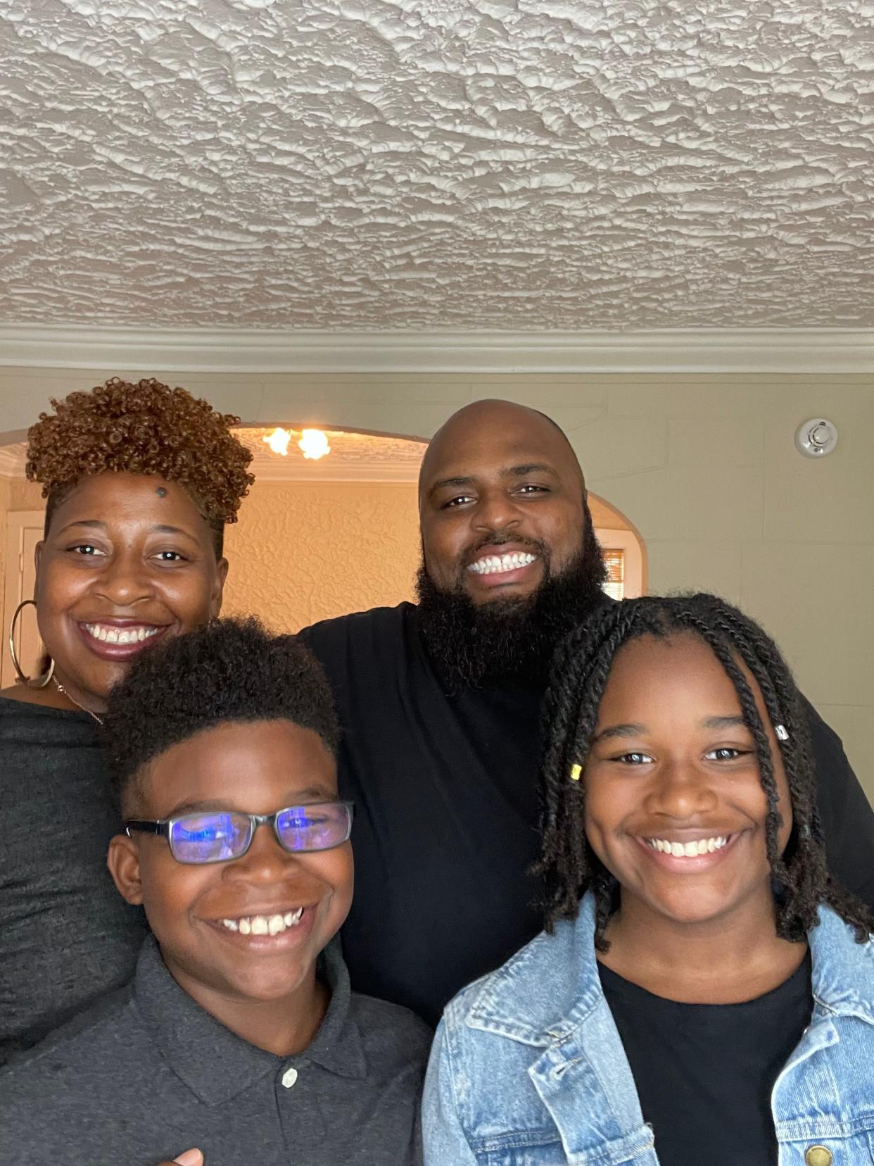 Symaria Glenn (bottom right) with her mother Dhima Martin, her brother Syon and her bonus dad, Jason Robinson.