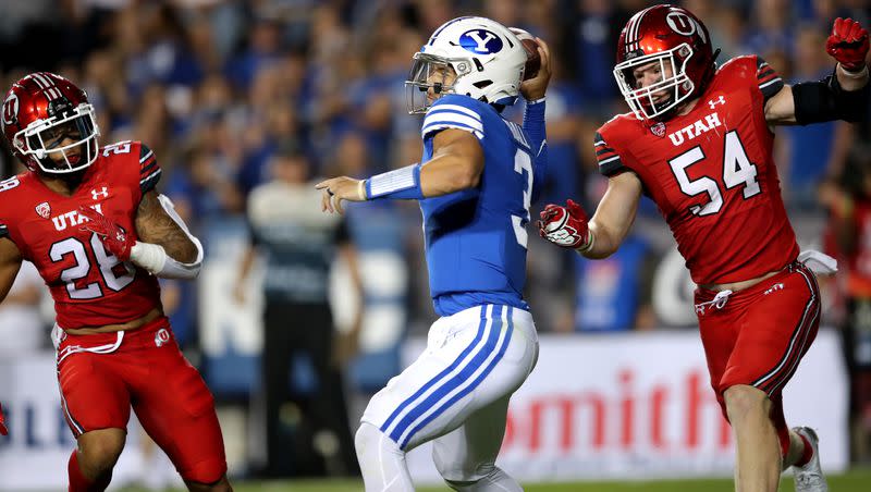 Utah safety Brandon McKinney and linebacker Hayden Furey (54) try to get to BYU quarterback Jaren Hall during game at LaVell Edwards Stadium in Provo on Saturday, Sept. 11, 2021. Could the two rivals soon be conference mates again?