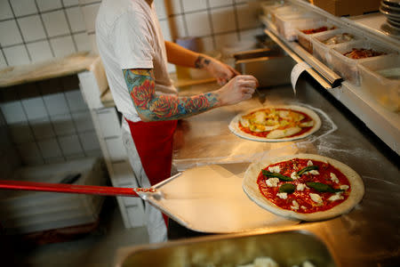 Pizza is prepared inside the Apollo Pizzeria, in London, Britain, January 22, 2019. REUTERS/Henry Nicholls