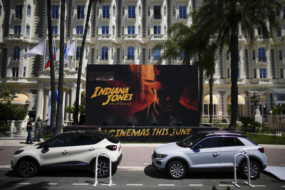 The official poster for 'Indiana Jones and the Dial of Destiny' is pictured in front of the Carlton hotel ahead of the Cannes film festival, in Cannes, southern France, Monday, May 15, 2023. The 76th edition of the film festival runs from May 16 until May 27. (AP Photo/Daniel Cole)