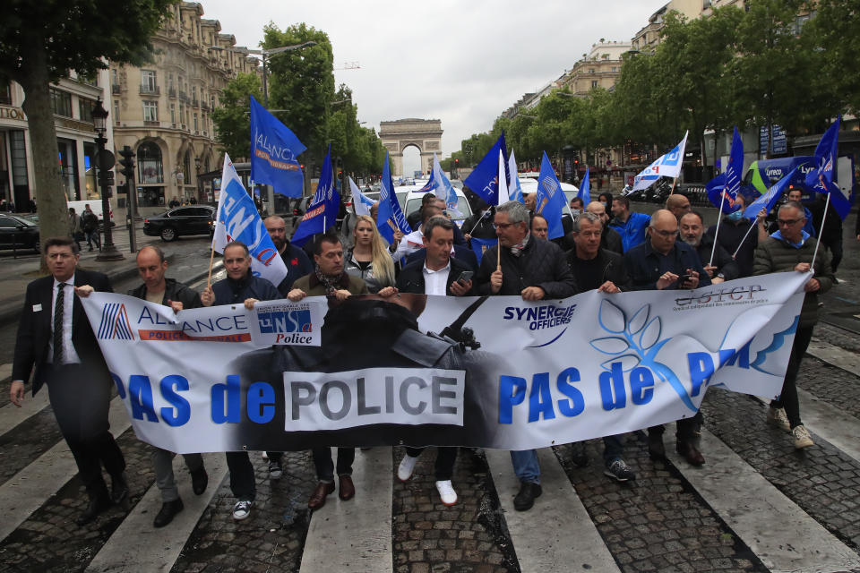 French police unionists demonstrate with a banner reading" No police, no peace" down the Champs-Elysee avenue, Friday, June 12, 2020 in Paris. French police are protesting a new ban on chokeholds and limits to what they can do during arrests, part of government efforts to stem police brutality and racism in the wake of global protests over George Floyd's death in the U.S. (AP Photo/Michel Euler)