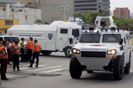 Riot police vehicles patrol during a rally to demand a referendum to remove Venezuela's President Nicolas Maduro in Caracas, Venezuela, September 1, 2016. REUTERS/Christian Veron