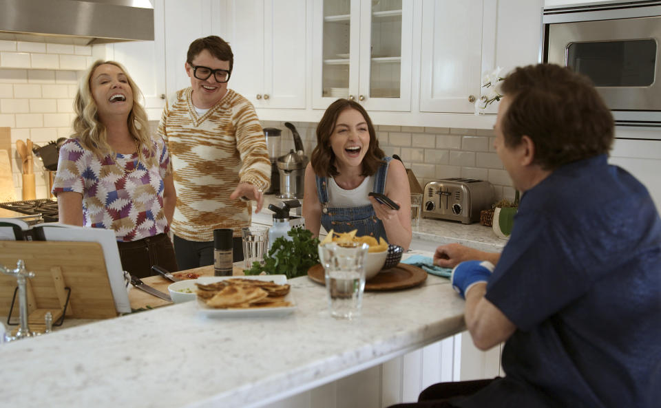 This image released by Apple TV+ shows, from left, Tracy Pollan, Sam Fox, Esme Fox and Michael J. Fox in a scene from the documentary "Still: A Michael J. Fox Movie." (Apple TV+ via AP)