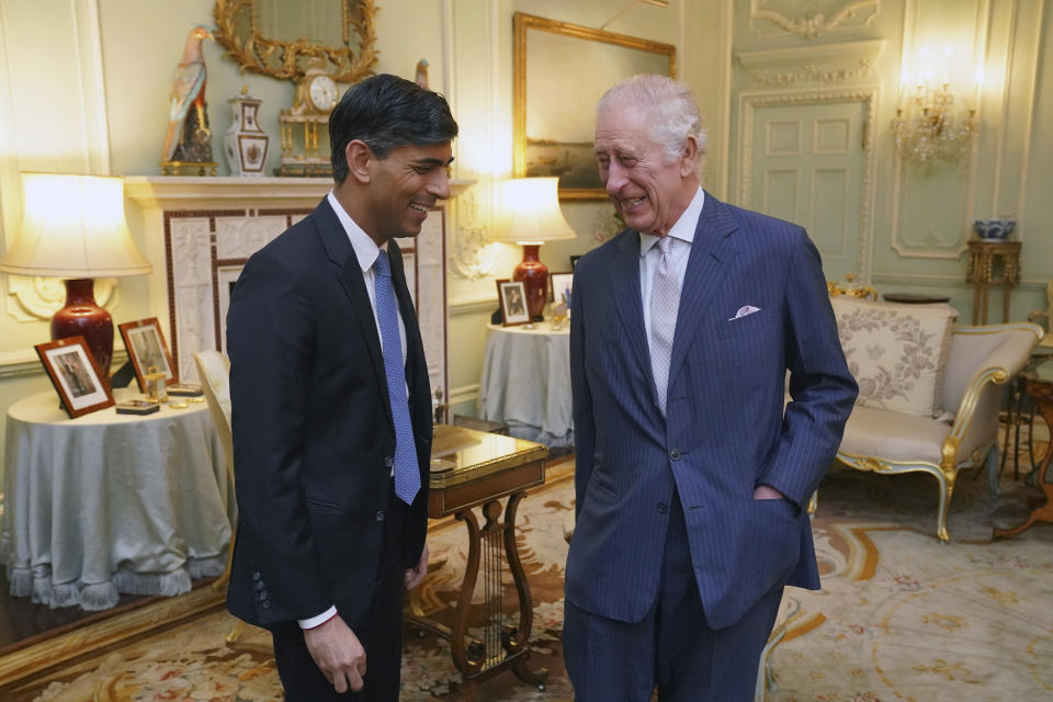 King Charles III, right, and Britain's Prime Minister Rishi Sunak smile during their meeting in Buckingham Palace, London, Wednesday, Feb. 21, 2024. (Jonathan Brady/Pool Photo via AP)