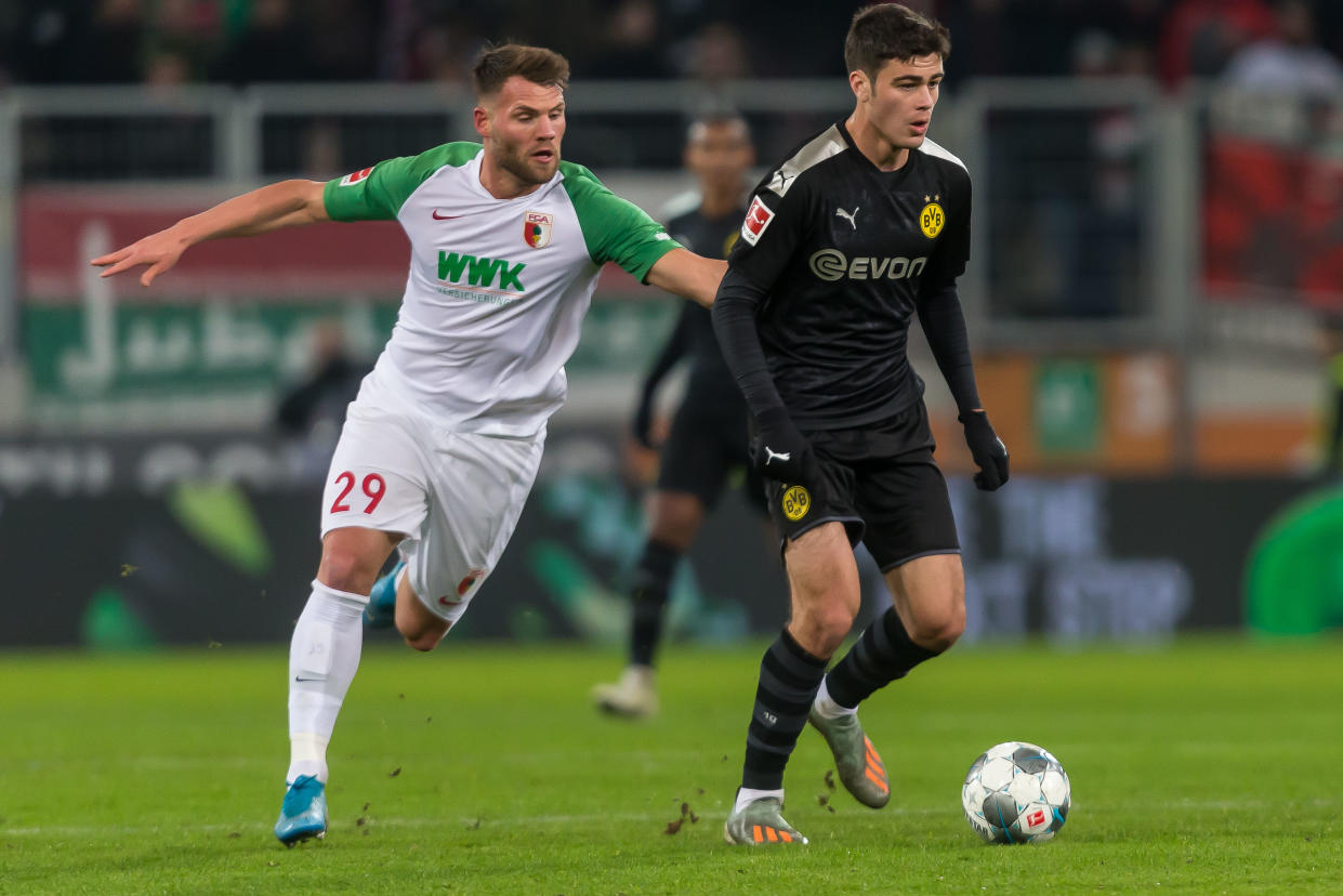 Borussia Dortmund's Giovanni Reyna (right) became the youngest American to play in the Bundesliga in Saturday's win over Augsburg. (Getty)