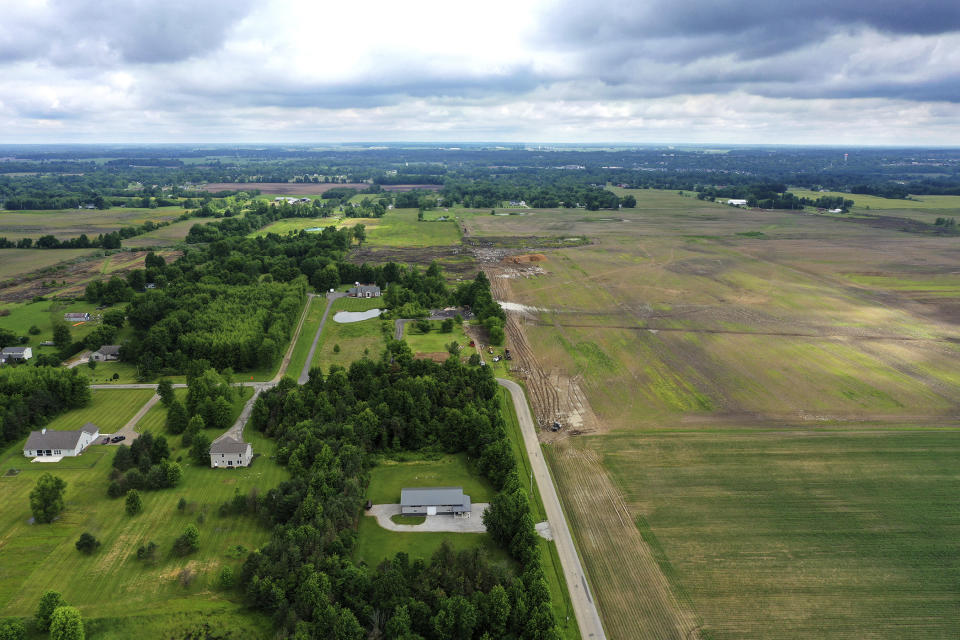 This aerial image taken with a drone on June 9, 2022 shows a portion of land in Johnstown, Ohio, where Intel plans to build two new processor factories. The houses on the left are up for demolition. The $20 billion project spans nearly 1,000 acres. Construction is expected to begin in 2022, with production coming online at the end of 2025. (AP Photo/Gene J. Puskar)