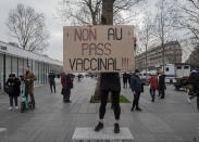 FILE - A demonstrator holds a placard that reads 'No to vaccine pass' in opposition to vaccine pass and vaccinations to protect against COVID-19 during a rally in Paris, France, Saturday, Jan. 22, 2022. The run-up to the April election comes in a context of mounting violence targeting elected officials in France, with holders of public officers targeted for their politics and by opponents of COVID-19 vaccinations restrictions. (AP Photo/Rafael Yaghobzadeh, File)