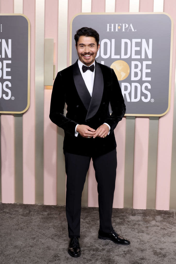 Henry Golding attends the 80th Annual Golden Globe Awards in a suit