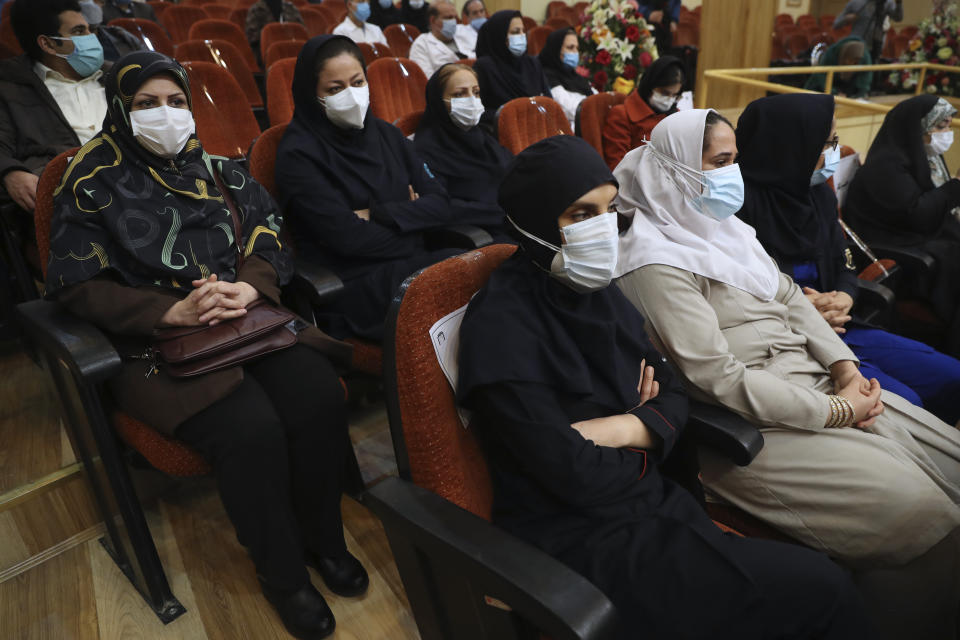 A group of medics from the Imam Khomeini Hospita, who volunteered to for receive the Russian Sputnik V coronavirus vaccine, sit prior to being injected at a staged event, in Tehran, Iran, Tuesday, Feb. 9, 2021. Iran on Tuesday launched a coronavirus inoculation campaign among healthcare professionals with recently delivered Russian Sputnik V vaccines as the country struggles to stem the worst outbreak of the pandemic in the Middle East with its death toll nearing 59,000. (AP Photo/Vahid Salemi)