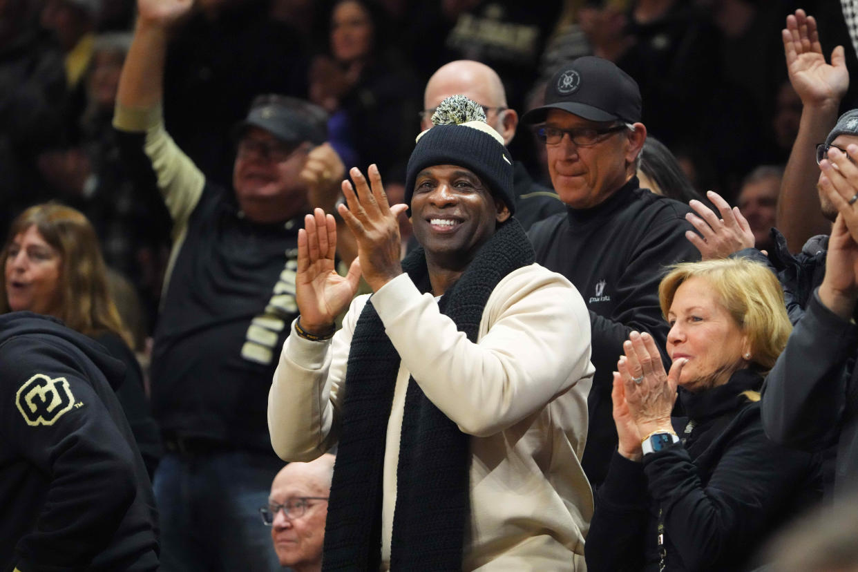 Colorado Buffaloes football coach Deion Sanders cheers at a game against the USC Trojans at the CU Events Center.