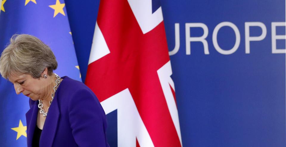 British Prime Minister Theresa May walks off the podium after a media conference during an EU summit in Brussels, Thursday, Oct. 18, 2018. EU leaders met for a second day on Thursday to discuss migration, cybersecurity and to try and move ahead on stalled Brexit talks. (AP Photo/Alastair Grant)