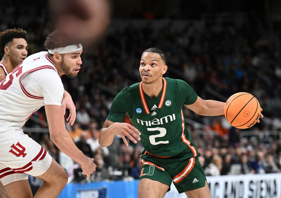 Miami guard Isaiah Wong (2) moves the ball afgainst Indiana during the second half of a second-round college basketball game in the men's NCAA Tournament on Sunday, March 19, 2023, in Albany, N.Y. (AP Photo/Hans Pennink)