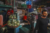 A vegetable vendor talks with a customer at a local market in Mumbai, India, Tuesday, July 23, 2024. India’s finance minister Nirmala Sitharaman on Tuesday unveiled the first full annual budget of the newly elected government following the national election. (AP Photo/Rafiq Maqbool)