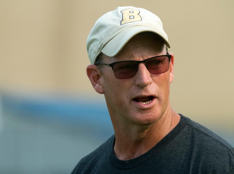 Boonville Head Coach Darin Ward calls a play as the Pioneers warm-up ahead of their scrimmage against the Reitz Panthers in Evansville, Ind., Thursday evening, July 22, 2021.