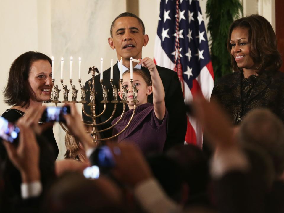 Barack and Michelle Obama watch the menorah lighting at one of the White House's Hanukkah receptions in 2013.