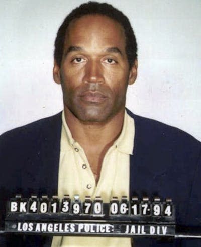 O.J. Simpson following his arrest in Los Angeles on June 17, 1994. <a href="https://www.gettyimages.com/detail/news-photo/in-this-handout-american-football-running-back-broadcaster-news-photo/1158571893?adppopup=true" rel="nofollow noopener" target="_blank" data-ylk="slk:Kypros/Getty Images;elm:context_link;itc:0;sec:content-canvas" class="link ">Kypros/Getty Images</a>