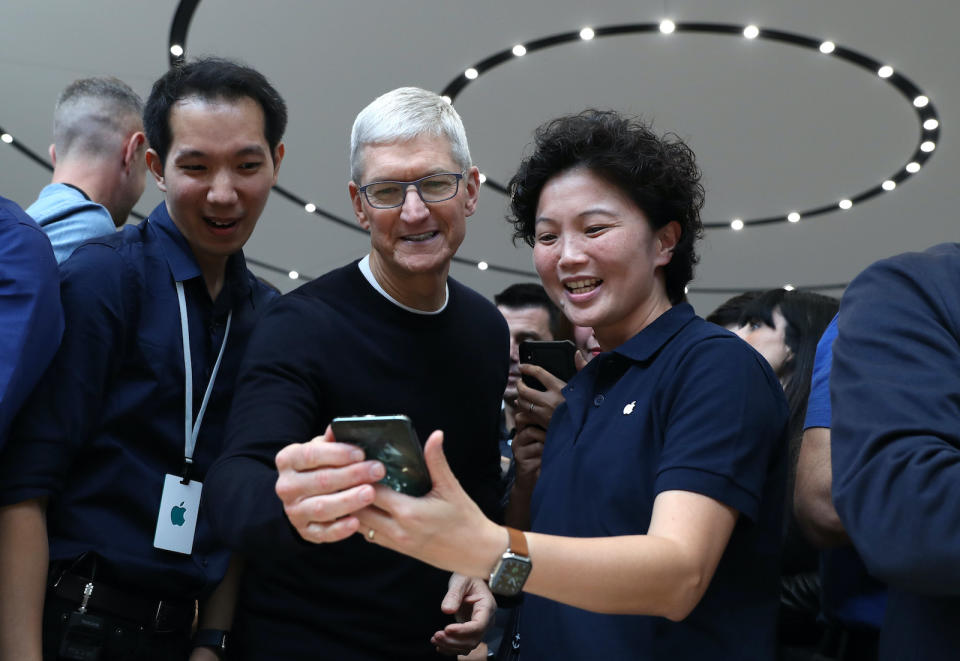 CUPERTINO, CALIFORNIA - SEPTEMBER 10: Apple CEO Tim Cook (C) looks at the new Apple iPhone 11 Pro during a special event on September 10, 2019 in the Steve Jobs Theater on Apple's Cupertino, California campus. Apple unveiled several new products including an iPhone 11, iPhone 11 Pro, Apple Watch Series 5 and seventh-generation iPad.  (Photo by Justin Sullivan/Getty Images)