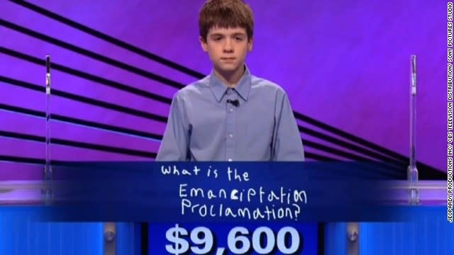 Young boy showing the spelling "What is the Emanciptation Proclamation" and the amount of $9,600
