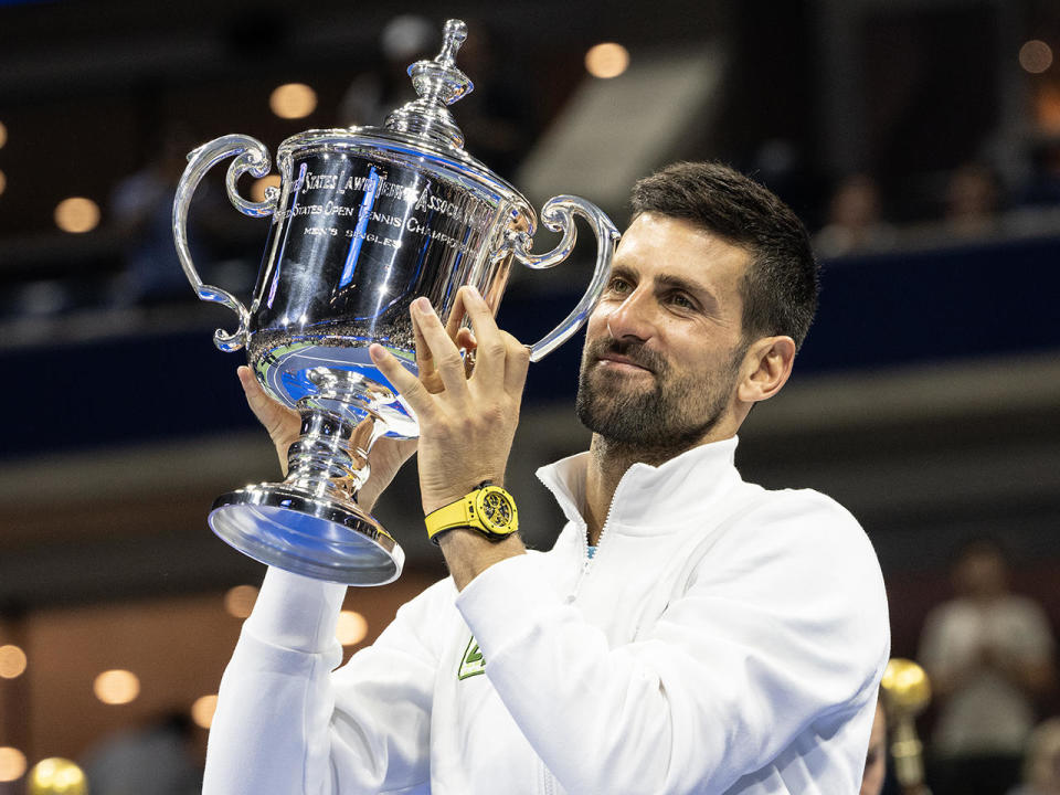 Novak Djokovic of Serbia poses with the championship trophy after winning the final against Daniil Medvedev at the U.S. Open in New York City, September 10, 2023. By winning, Djokovic has equaled the record of 24 Grand Slam titles held by Margaret Court. / Credit: Lev Radin/Anadolu Agency via Getty Images